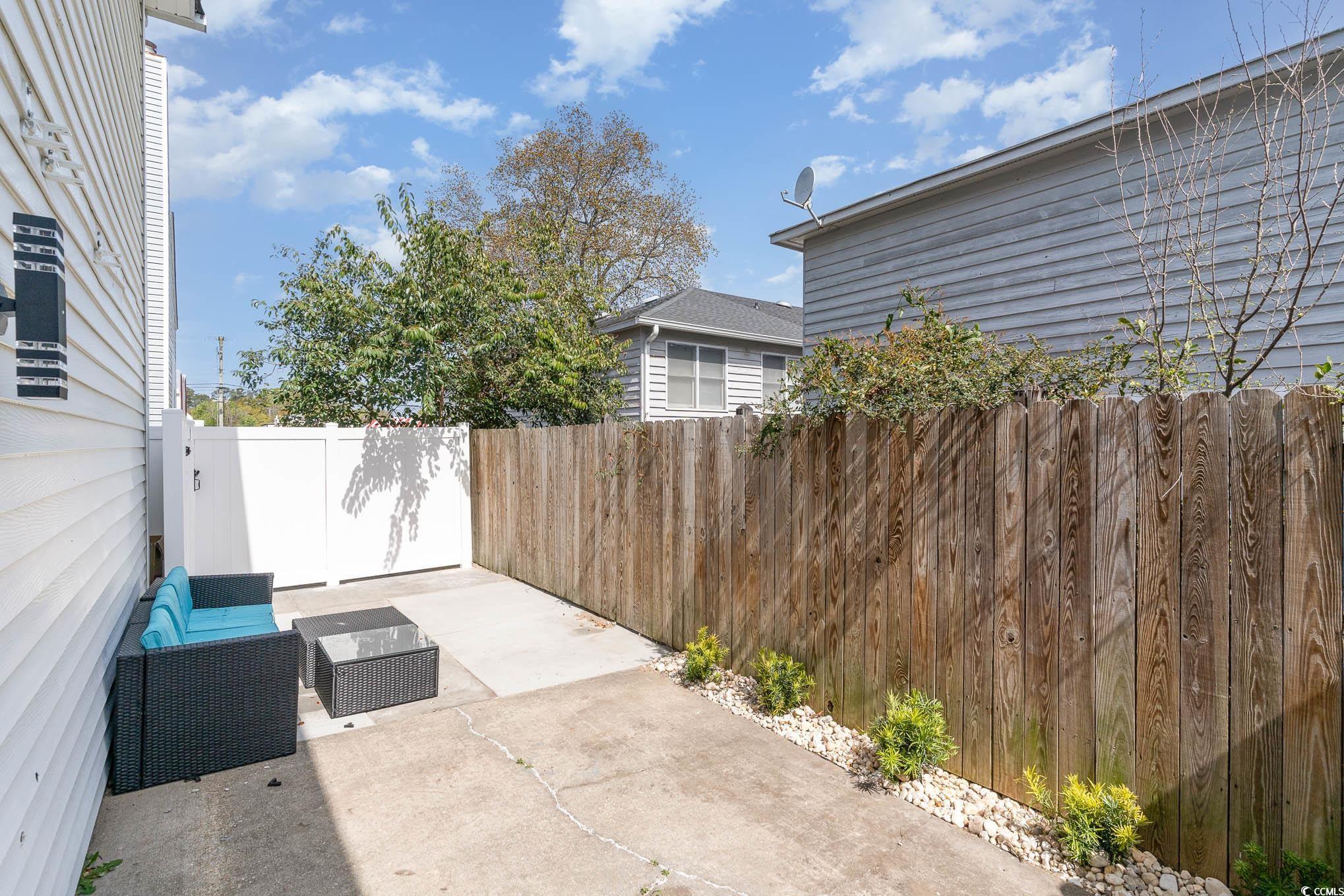 412 27th Avenue North Myrtle Beach, SC 29577 - Photo 26 of 35 Fenced backyard with a patio area and an outdoor living space