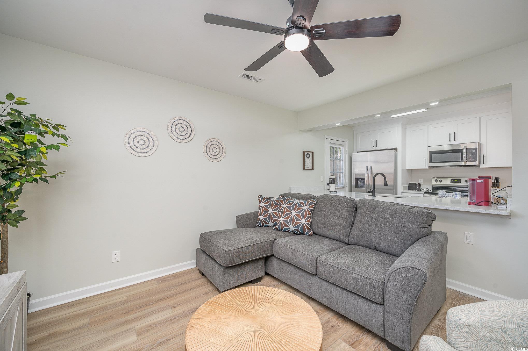 412 27th Avenue North Myrtle Beach, SC 29577 - Photo 4 of 35 Living room with light wood finished floors and ceiling fan