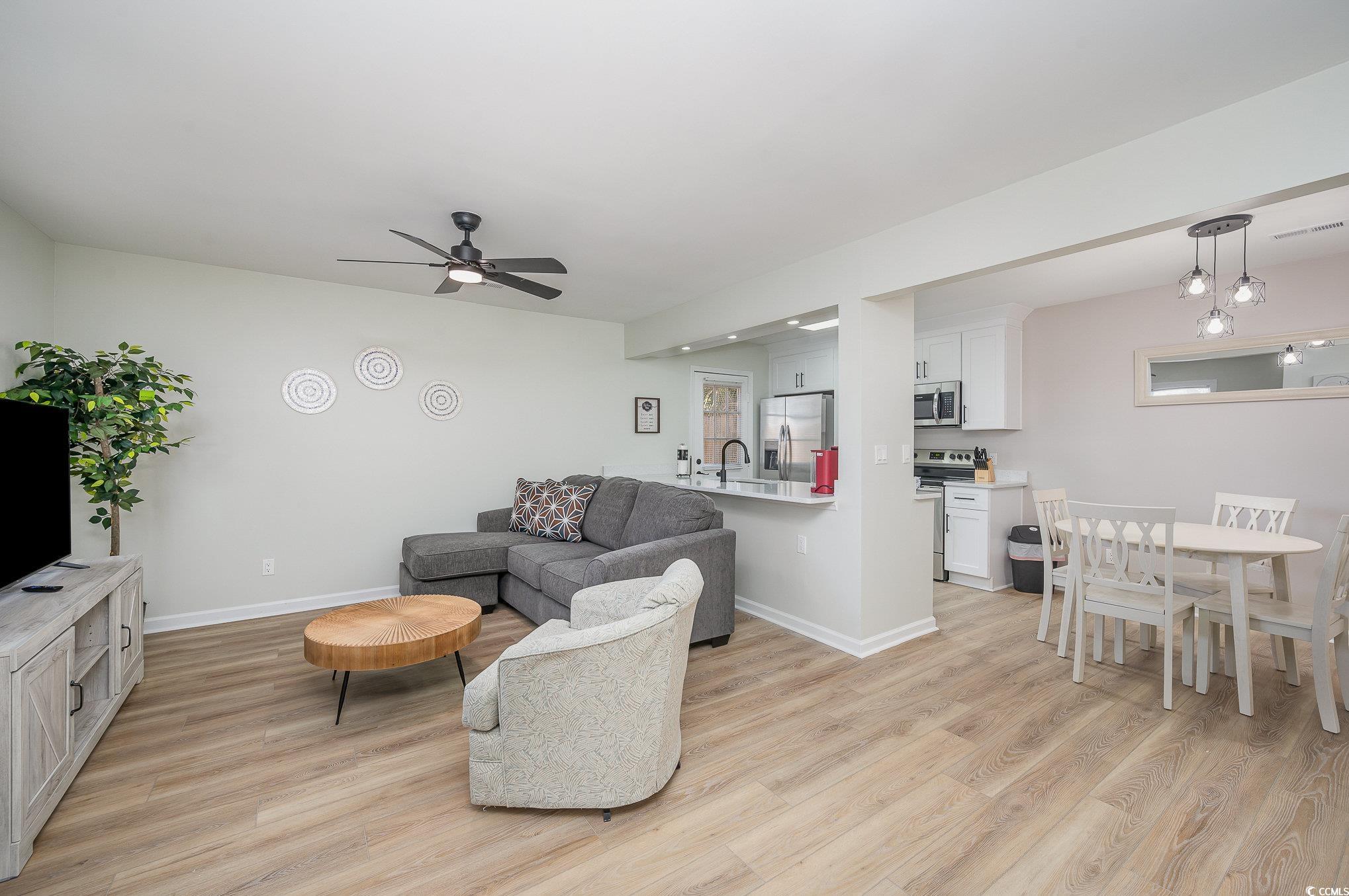 412 27th Avenue North Myrtle Beach, SC 29577 - Photo 5 of 35 Living room with light wood-style flooring and a ceiling fan