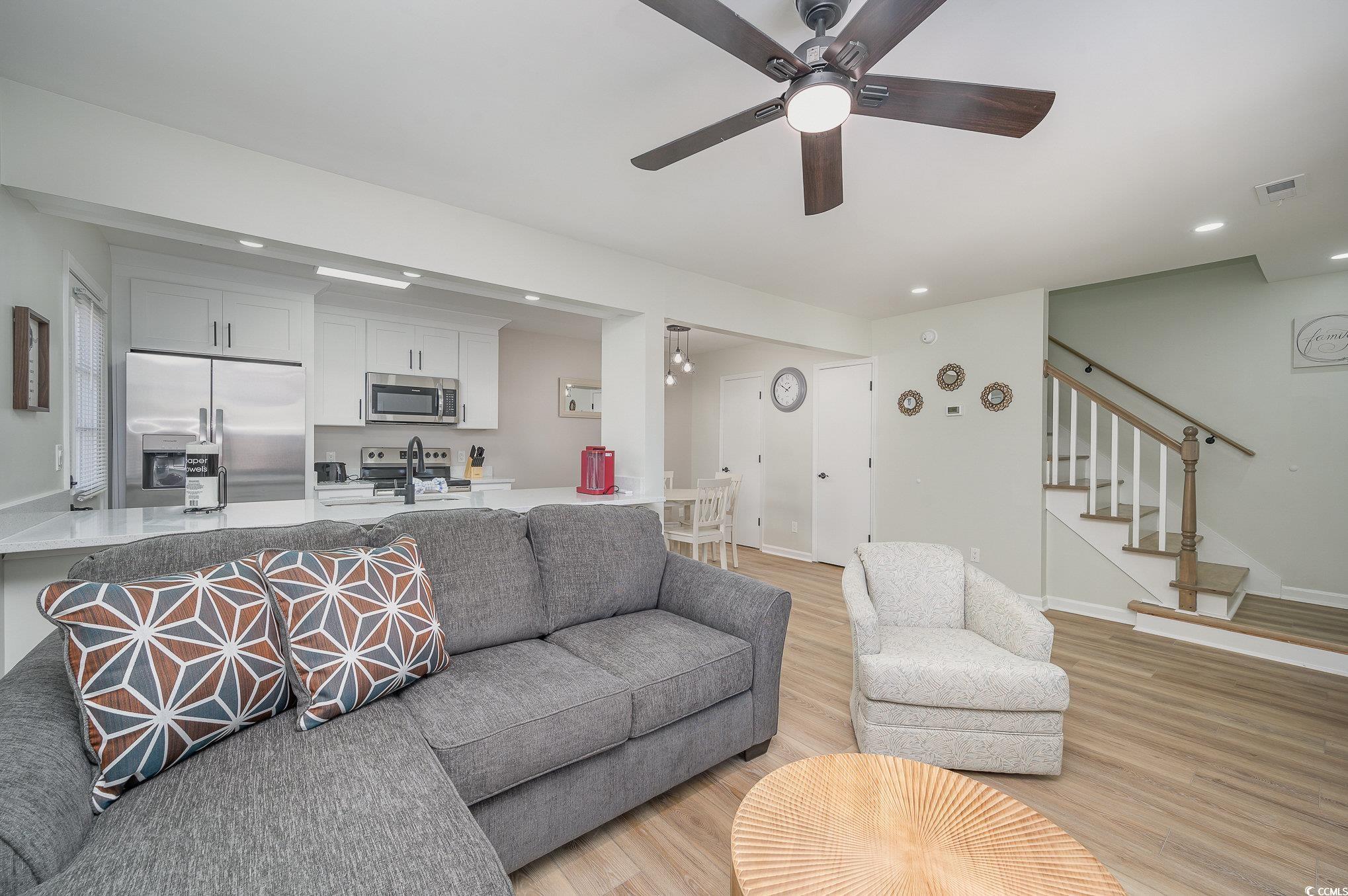 412 27th Avenue North Myrtle Beach, SC 29577 - Photo 6 of 35 Living area featuring light wood-type flooring, stairs, a ceiling fan, and recessed lighting