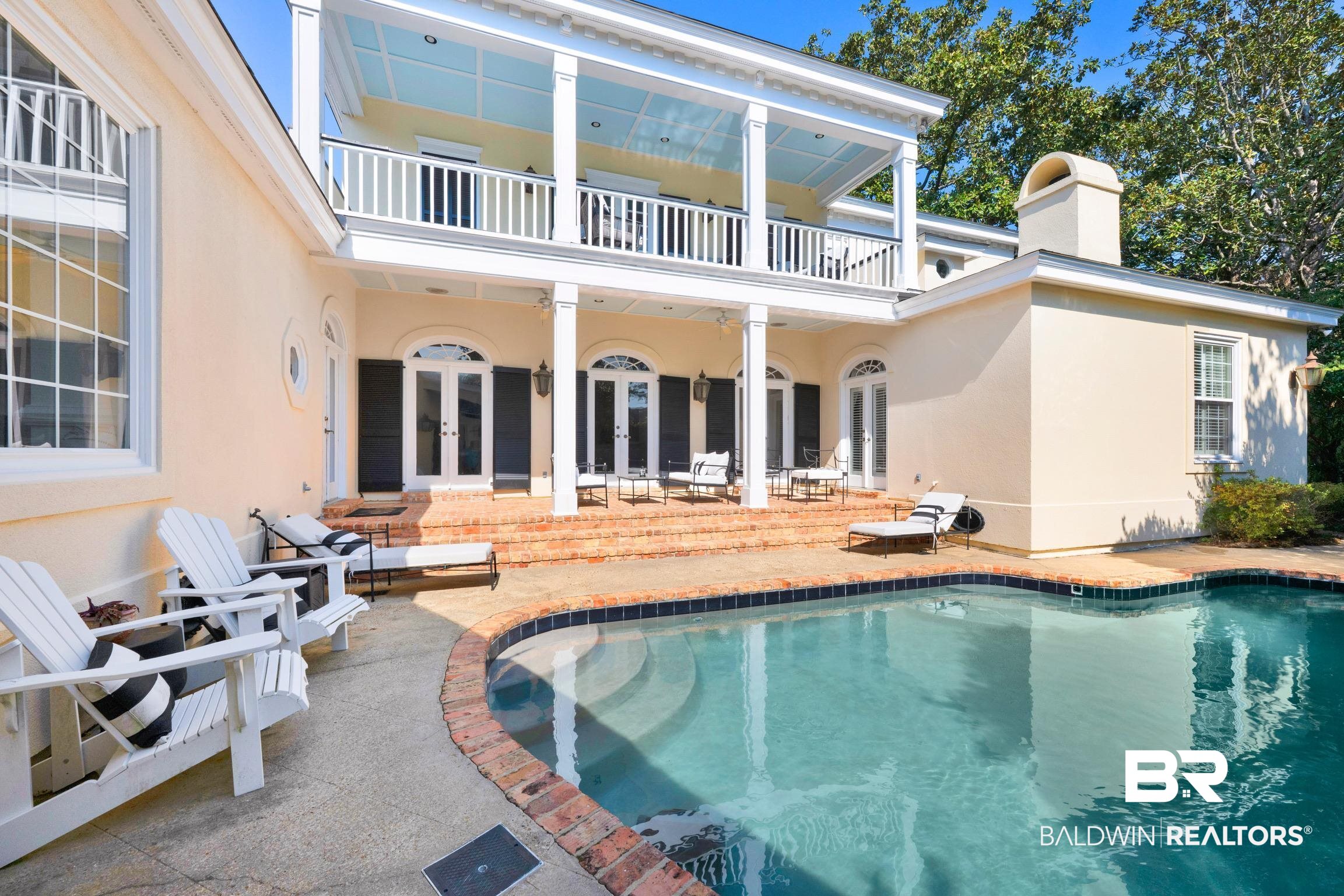 4 Savannah Court Mobile, AL 36608 - Photo 2 of 32 Rear view of house featuring a patio, french doors, an outdoor pool, and stucco siding