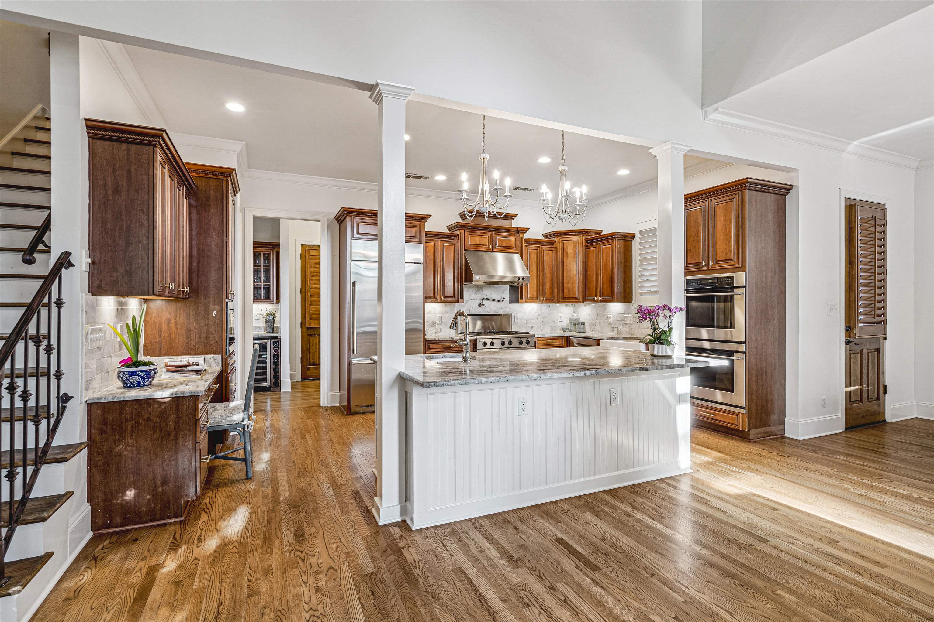 3084 Devonshire Way Germantown, TN 38139 - Photo 16 of 40 Kitchen featuring light stone counters, ornamental molding, wood finish cabinetry, stainless steel appliances, and a center island with sink