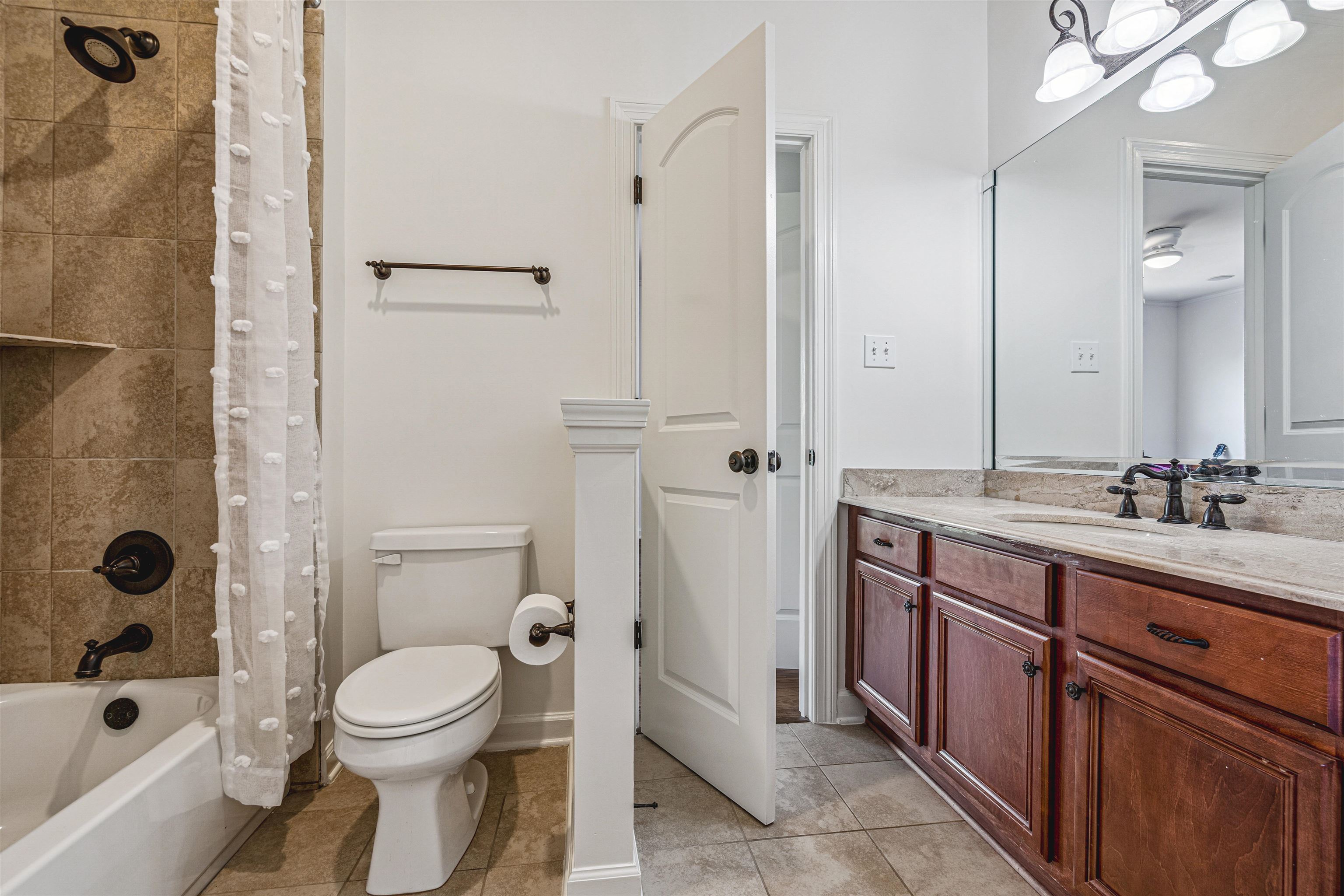 3084 Devonshire Way Germantown, TN 38139 - Photo 25 of 40 Full bath featuring vanity, shower / bathtub combination with curtain, and light tile patterned floors