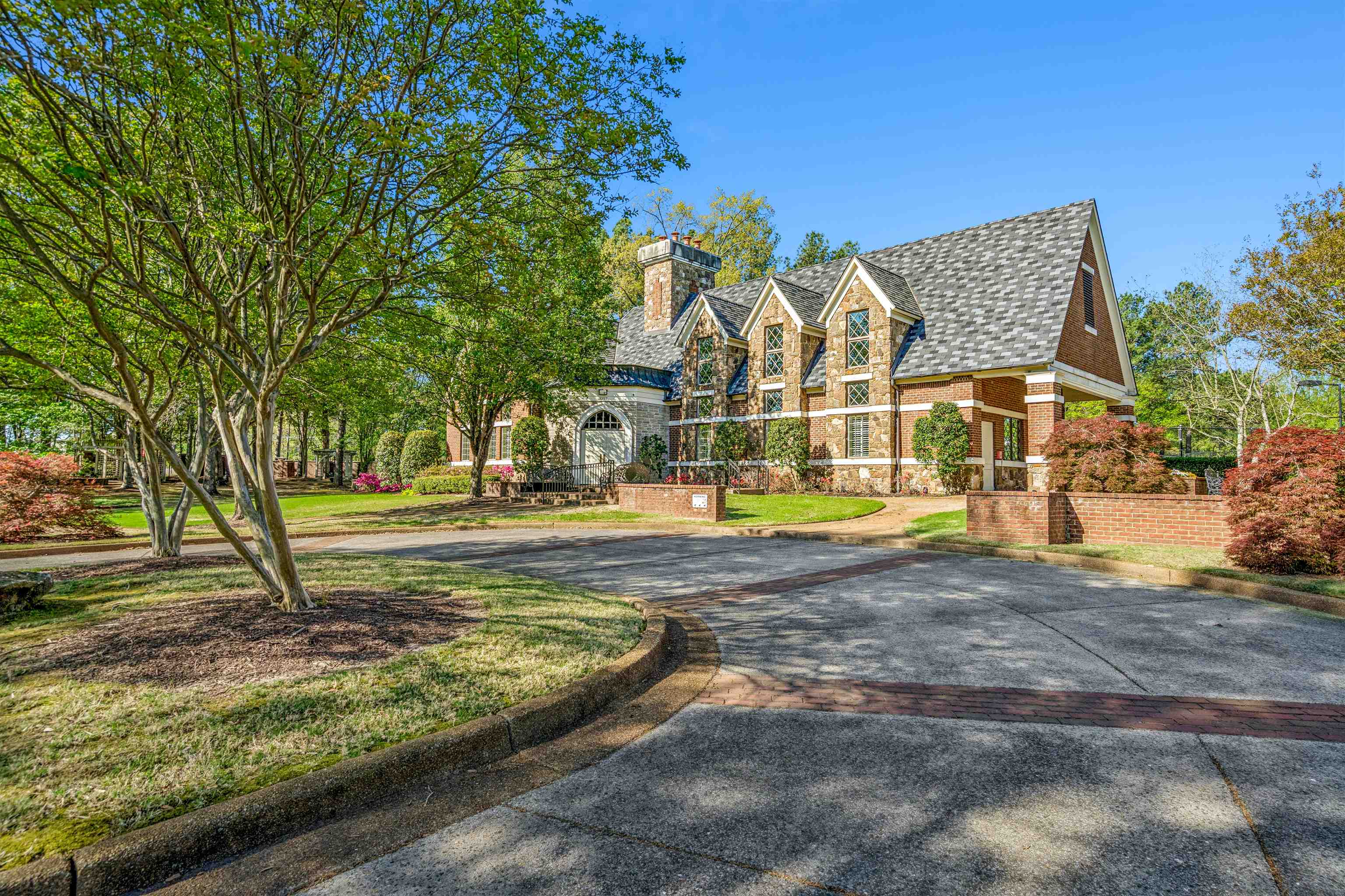 3084 Devonshire Way Germantown, TN 38139 - Photo 39 of 40 Tudor-style house with a chimney, stone siding, brick siding, and driveway