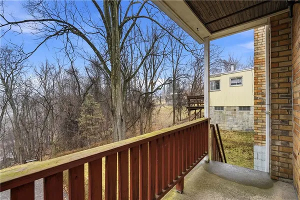 a view of a balcony with wooden fence and floor