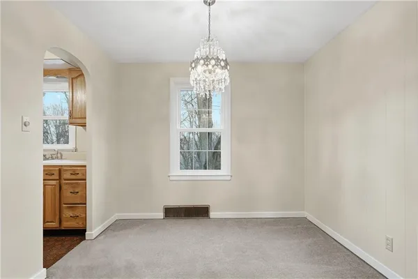 an empty room with windows and entrance