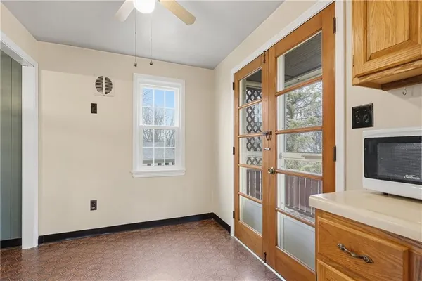 a view of an empty room with a fireplace and a window