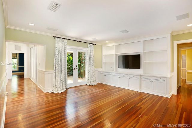 a room with a bed and a flat screen tv