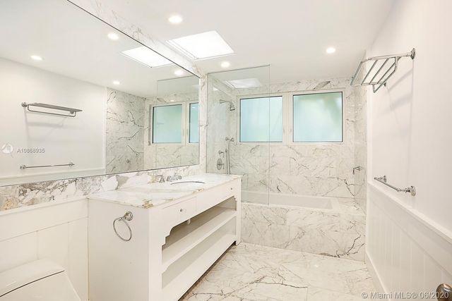 a bathroom with a sink a mirror and a bathtub