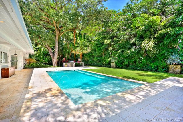 a view of backyard with swimming pool