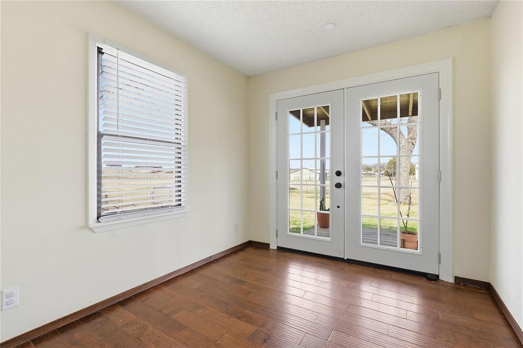 9213 Wilson Road Pilot Point, TX 76258 - Photo 19 of 36 Interior space featuring wood-finish flooring, light-toned walls, and a textured ceiling