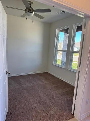 an empty room with windows and closet