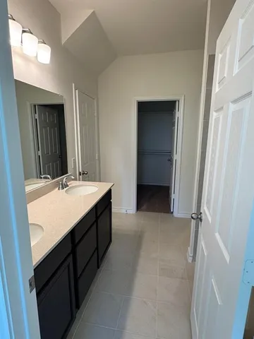 a bathroom with a double vanity sink a and a mirror