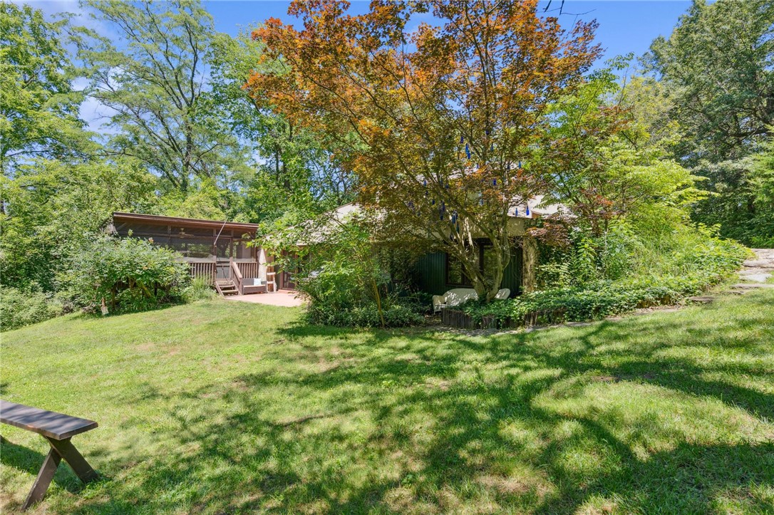 1940 Armstrong Road Fairborn, OH 45324 - Photo 36 of 48 This verdant property features a charming home nestled among lush trees, offering a tranquil retreat.