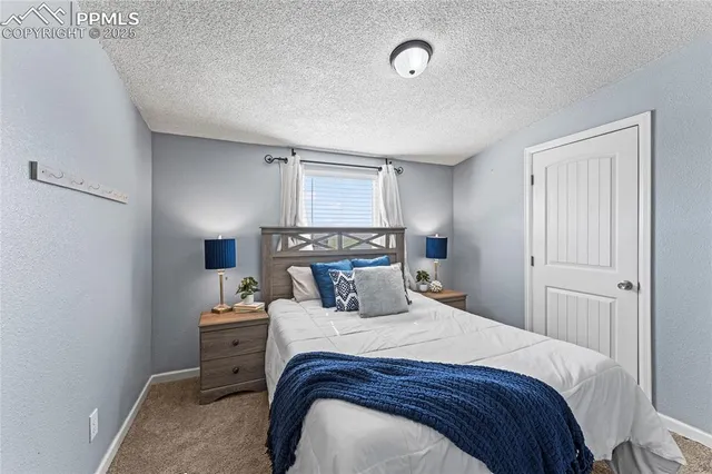 a bedroom with a bed and a lamp