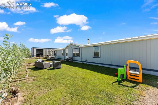 a view of a house with swimming pool and sitting area