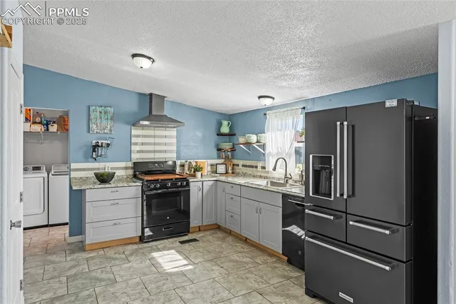 a kitchen with a stove sink and refrigerator