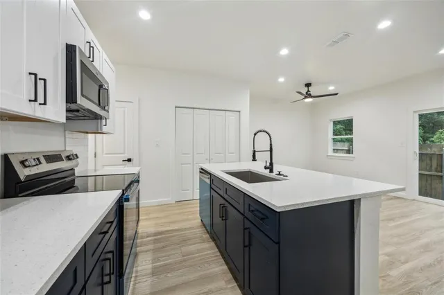 a view of a hallway with wooden floor and stairs