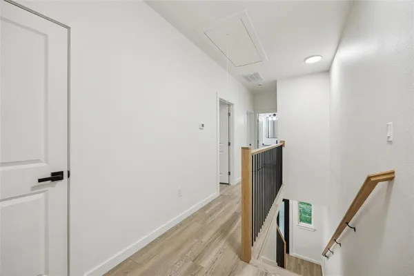 a view of a kitchen with a sink and wooden floor