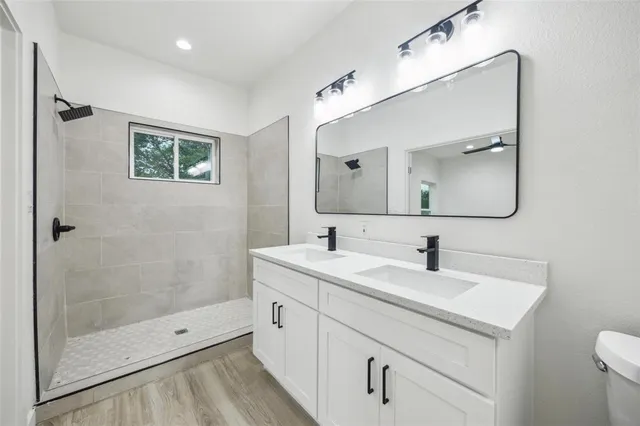 a bathroom with a toilet sink and mirror