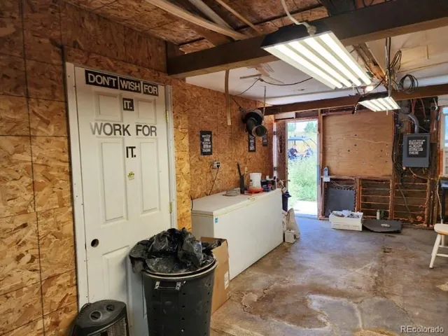 a living room with patio furniture and a wooden floor