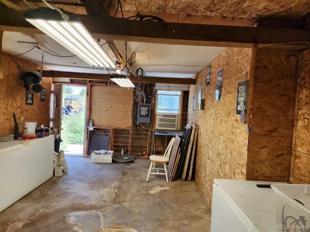 a view of living room kitchen with furniture and a fireplace