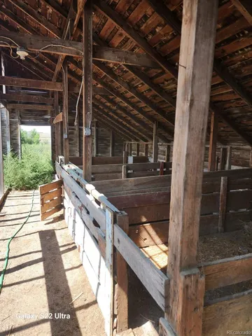 a balcony with stainless steel appliances wooden floor and view of living room