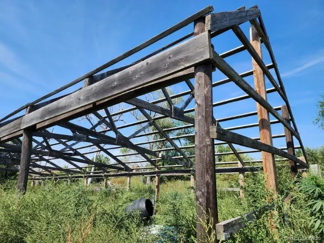 a backyard of a house with a deck and plants