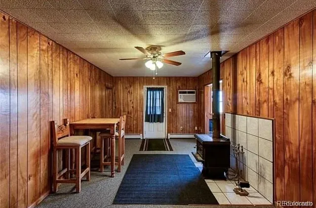 a view of a hallway with furniture and chandelier