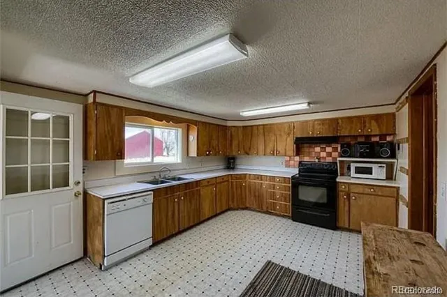 a kitchen with stainless steel appliances granite countertop a stove sink and cabinets