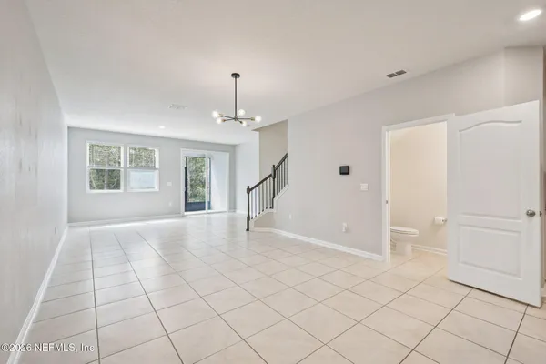 a view of an empty room with window and cabinet