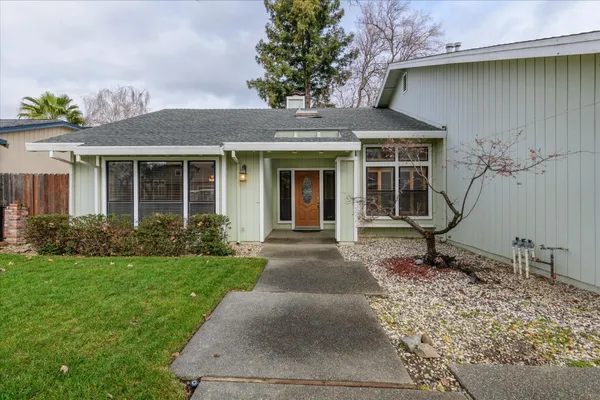 a front view of a house with garden
