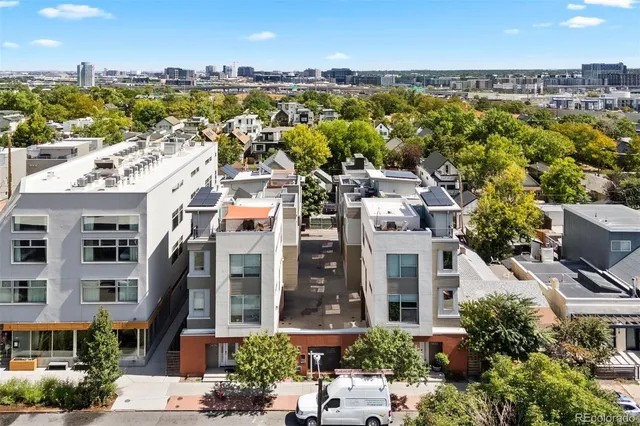 an aerial view of residential building with parking