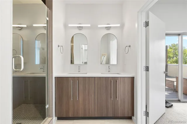 a bathroom with a double vanity sink and a mirror