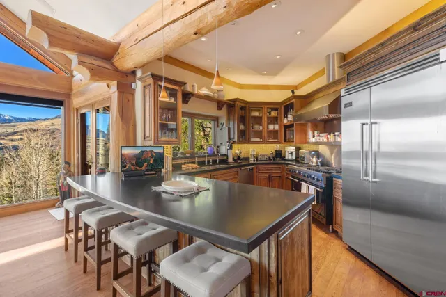 a kitchen with a table chairs stove and kitchen island