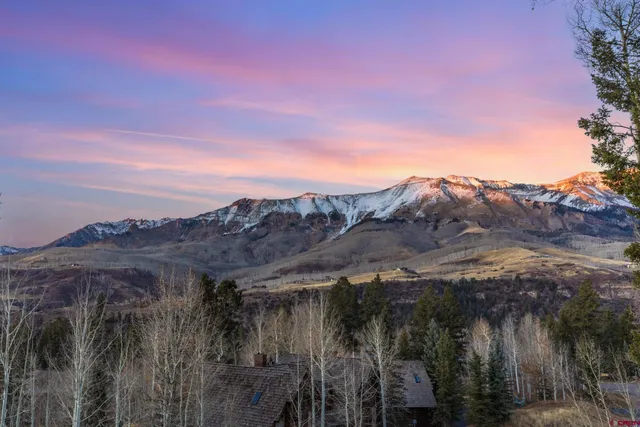 a view of a town with mountains in the background