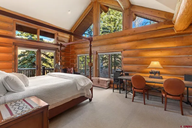 a bedroom with a bed chair and window