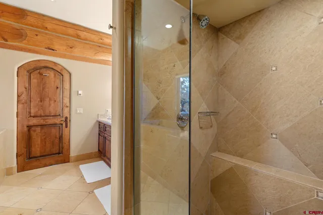 a bathroom with a granite countertop sink a toilet and shower