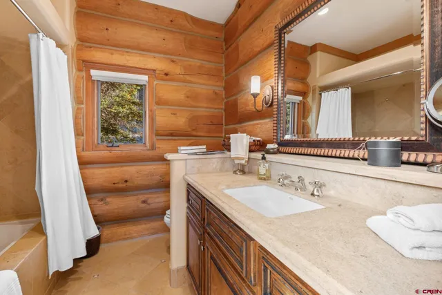 a en suite bathroom with a sink and a mirror