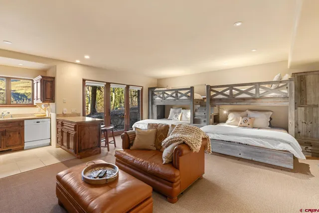 a bedroom with a large bed and a couch