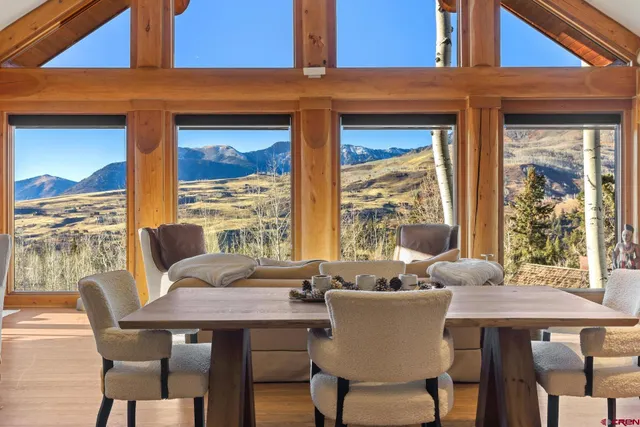 a dining room with furniture wooden floor and a potted plant