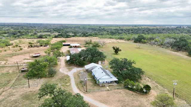 an aerial view of lake residential house with outdoor space and trees around