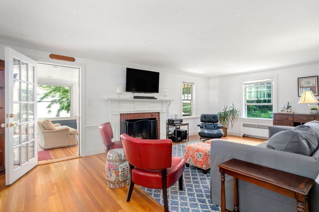 32 Verndale Road Newton, MA 02461 - Photo 11 of 33 a living room with furniture a fireplace and a flat screen tv