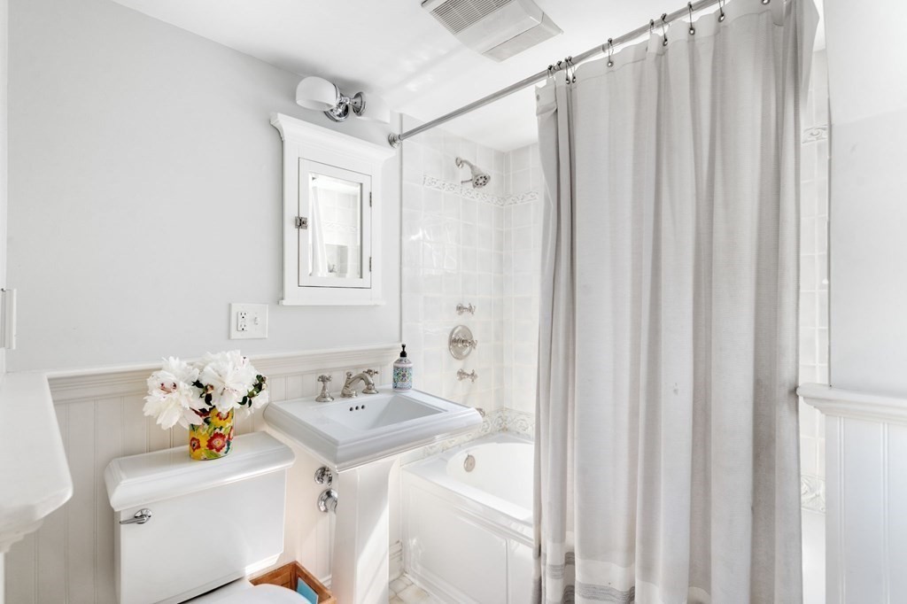 32 Verndale Road Newton, MA 02461 - Photo 15 of 33 a bathroom with a sink a toilet and shower curtain