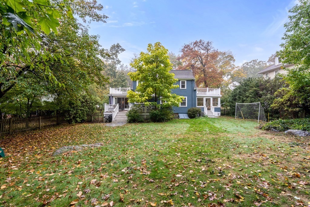 32 Verndale Road Newton, MA 02461 - Photo 28 of 33 a yellow house with a yard and a large tree