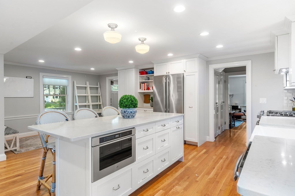 32 Verndale Road Newton, MA 02461 - Photo 8 of 33 a kitchen with stainless steel appliances kitchen island granite countertop a lot of counter space and wooden floors