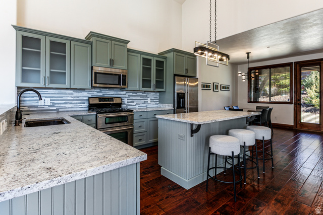5326 North Oldgate Road Heber City, UT 84032 - Photo 7 of 32 Modern kitchen with a substantial island featuring a stone countertop