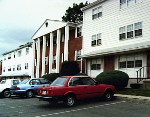 a front view of a house with parking space