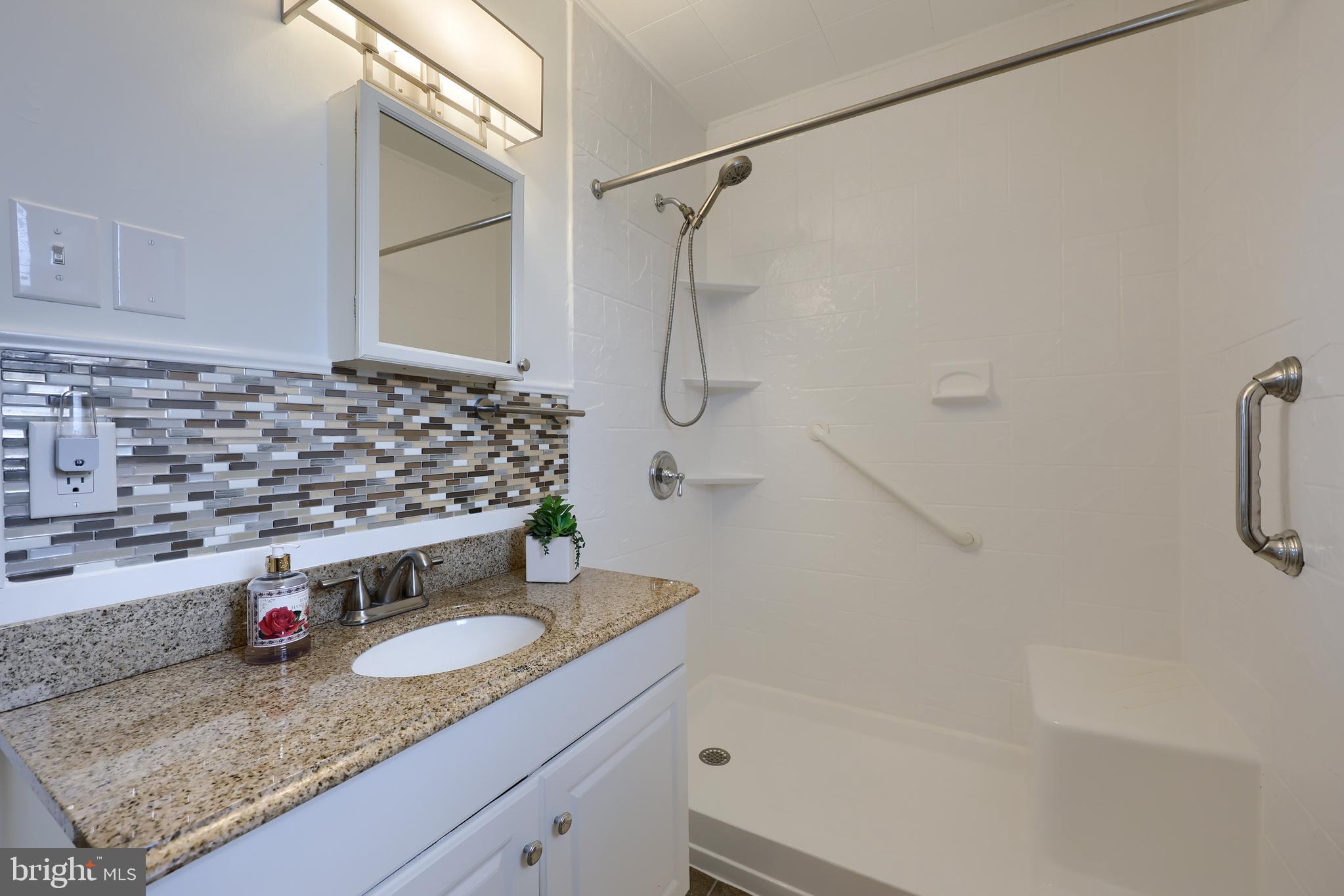 1802 Filbert Street York, PA 17404 - Photo 12 of 30 a bathroom with a granite countertop sink and a mirror