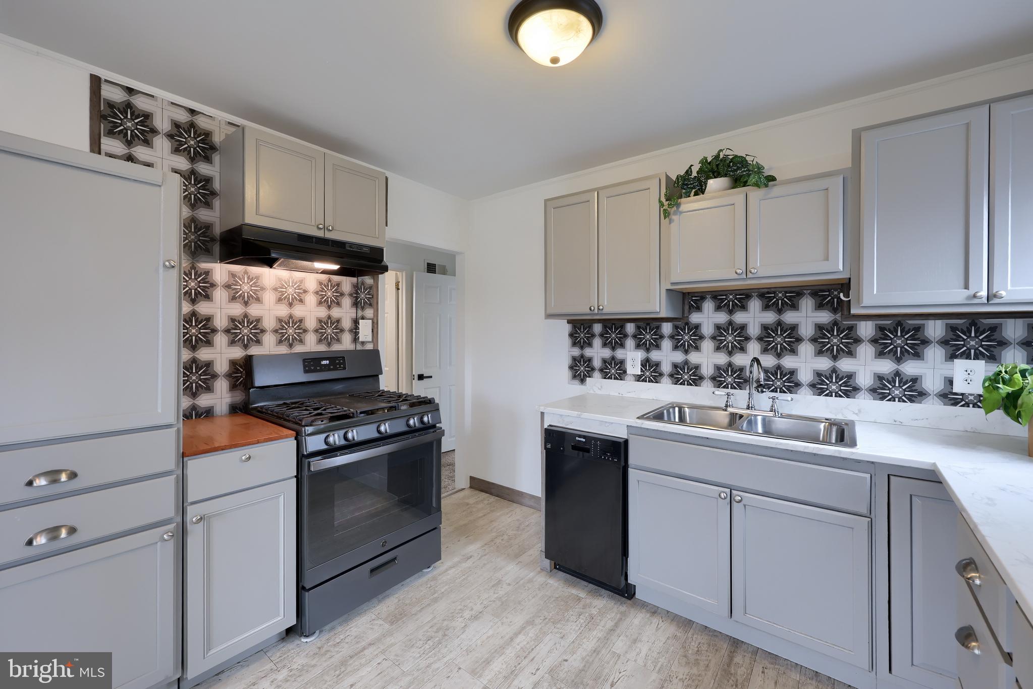 1802 Filbert Street York, PA 17404 - Photo 15 of 30 a kitchen with stainless steel appliances a sink stove and cabinets